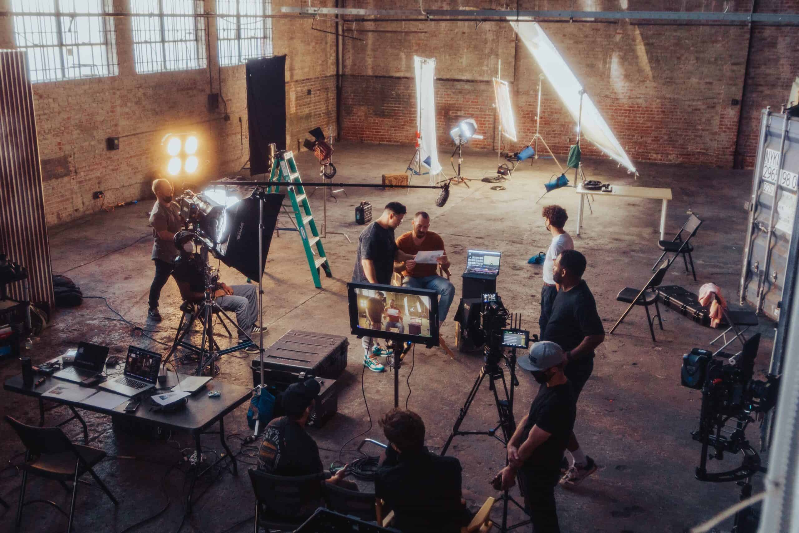 people in warehouse filming