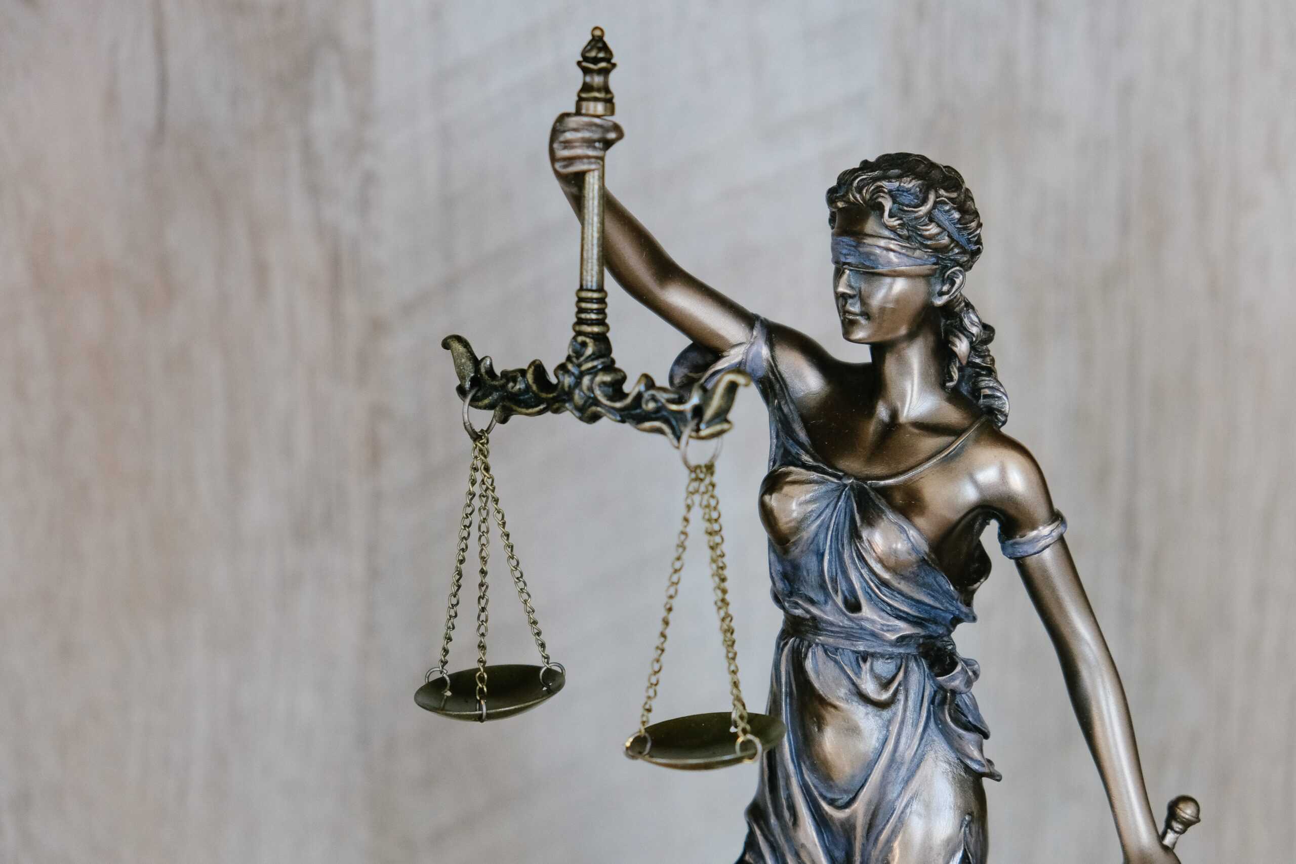 blindfolded woman holding scales of justice 