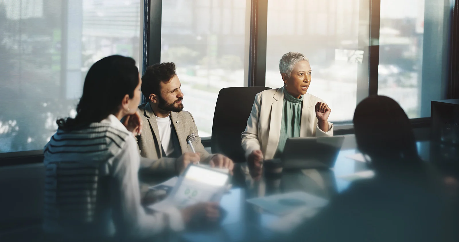 People sitting around a conference table in a meeting.