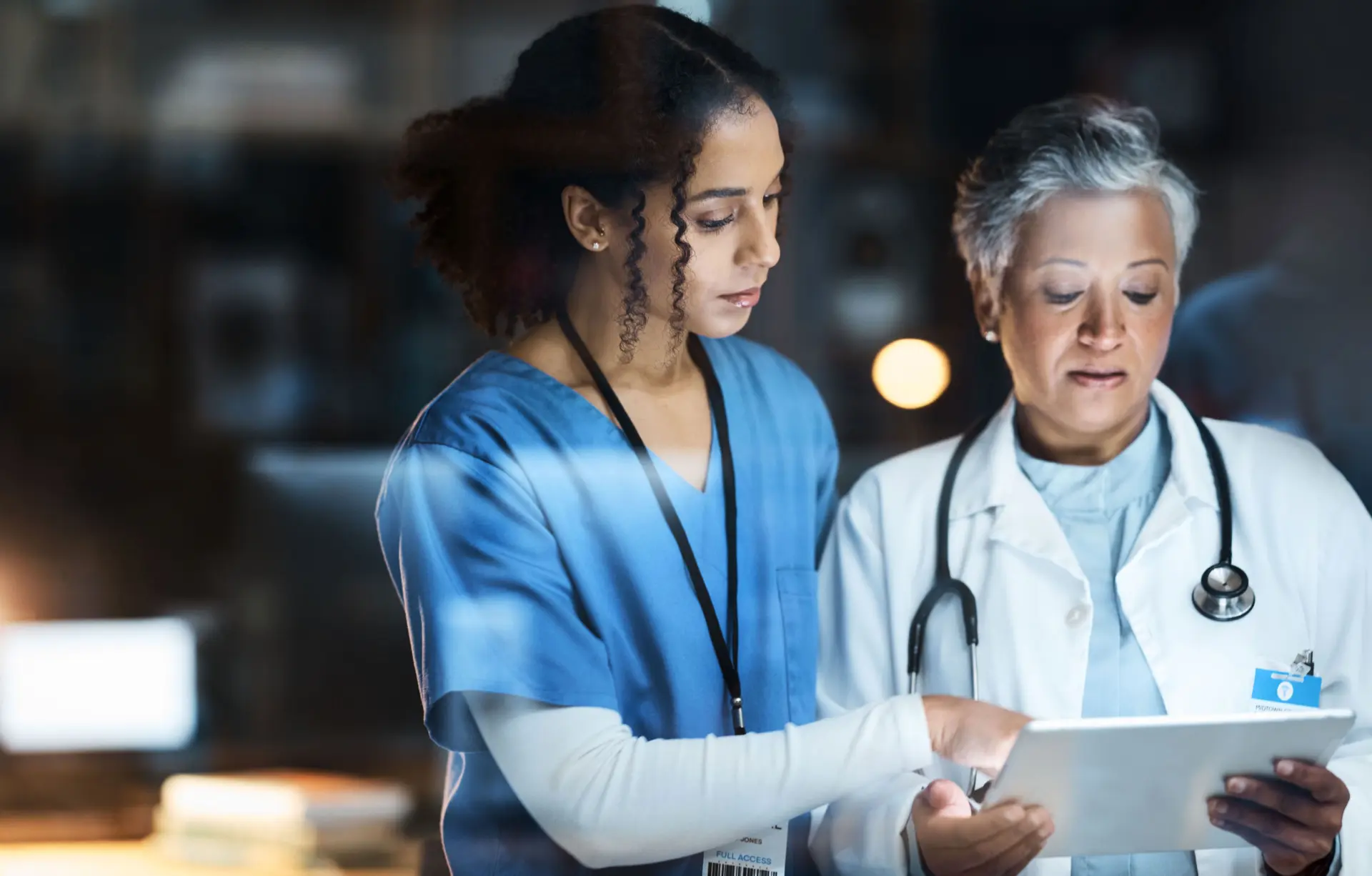 Women, doctors and tablet for night medical research, surgery planning and teamwork in hospital.