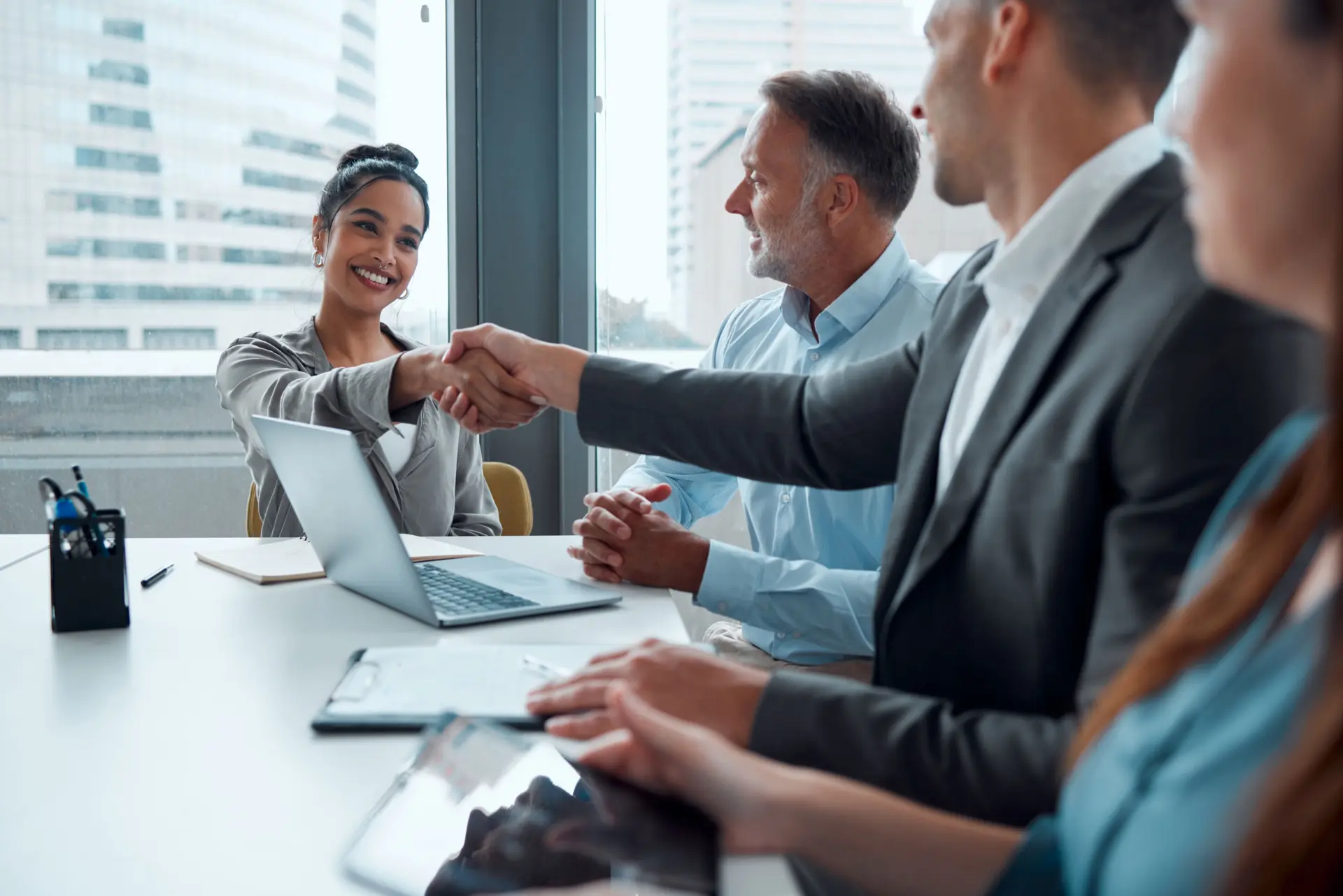 Business woman, handshake and partnership meeting for b2b interview, contract and thank you in office. Teamwork, corporate tech employees and shaking hands for happy onboarding conversation or deal
